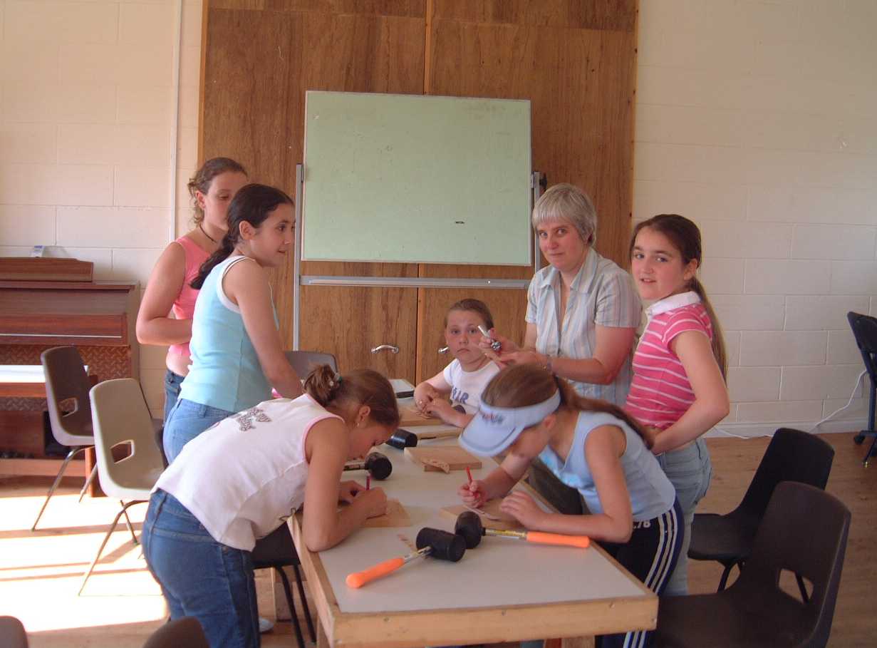 Anna teaching leather crafts